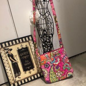 Vera Bradley  Cross body has zipper/pouches.approximately 8 1/2 x 9”
